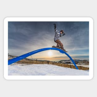 Snowboarder sliding on a rail Sticker